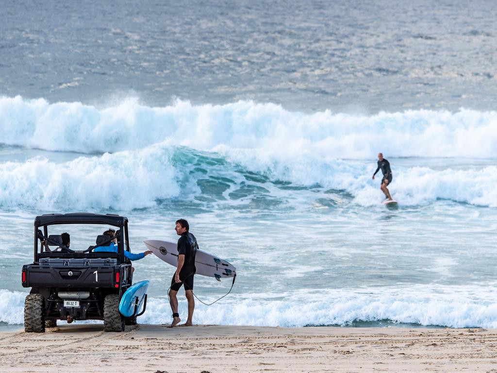 Surfers ordered to stop surfing by lifeguards at Bondi Beach at 7.30am on Sunday, 19 April 2020. Picture: Monique Harmer