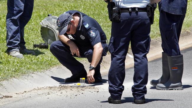 Queensland Police searching for clues in the drain outside the Brinsmead house. They would find Ms Cao’s porcelain teeth in gravel.