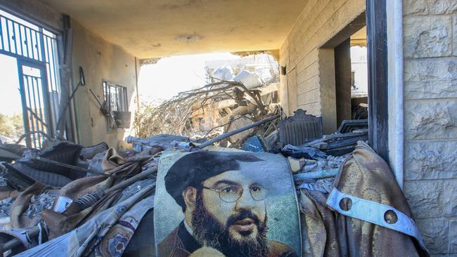 A portrait of Hezbollah chief Hassan Nasrallah – days before an Israel airstrike killed him in Lebanon last month – sits amid destruction in an area targeted by Israeli airstrikes. Picture: Mahmoud Zayyat / AFP