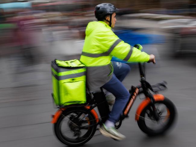 SYDNEY, AUSTRALIA - NewsWire Photos MAY 10 2024. GENERIC. Economy, cost of living, budget. Food delivery rider in the CBD. Picture: NCA NewsWire / Max Mason-Hubers