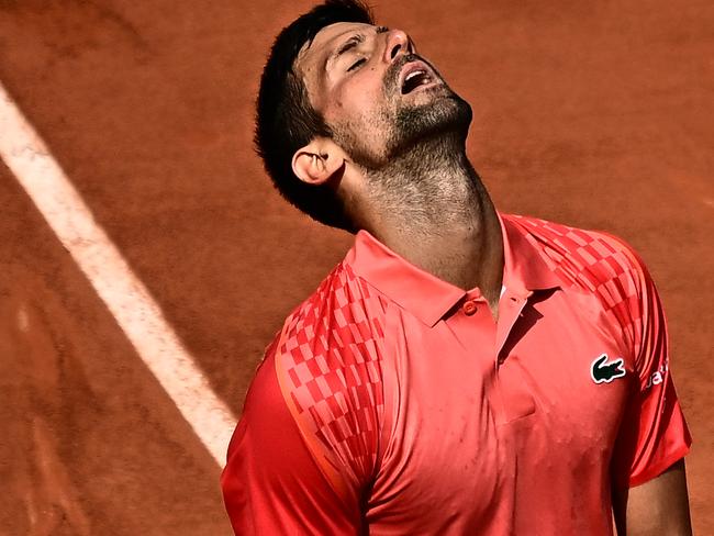 TOPSHOT - Serbia's Novak Djokovic reacts as he plays against Spain's Carlos Alcaraz Garfia during their men's singles semi-final match on day thirteen of the Roland-Garros Open tennis tournament at the Court Philippe-Chatrier in Paris on June 9, 2023. (Photo by JULIEN DE ROSA / AFP)