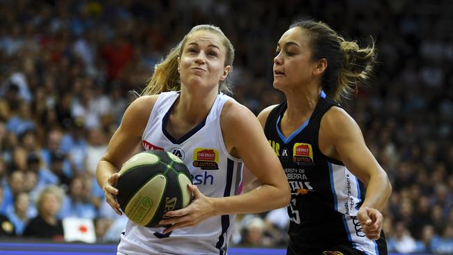 Aimee Clydesdale of the Adelaide Lightning drives against Leilani Mitchell of the Canberra Capitals. Picture: AAP