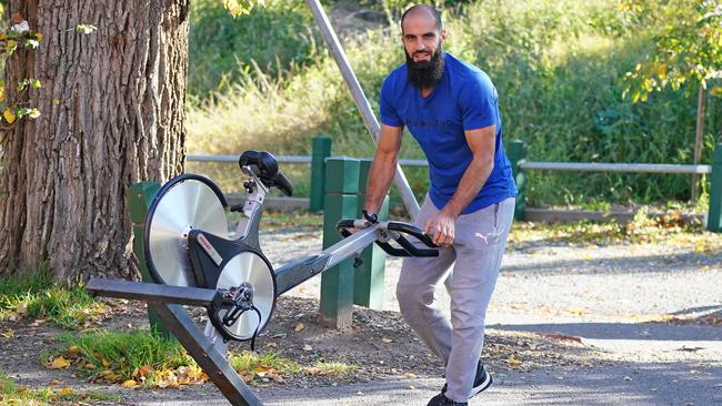 Richmond player Bachar Houli returns an exercise bike to the Tigers’ clubrooms at Punt Road Oval on Sunday, with teams set to resume training on Monday. Picture: AAP