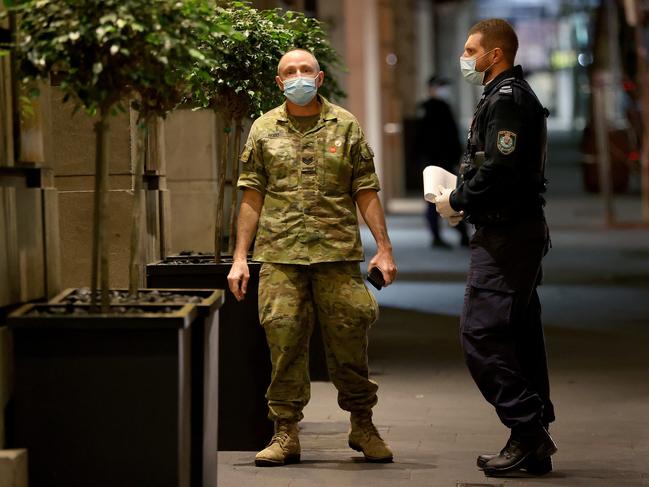Australian Defence Force personnel will be rolled out across Sydney to help with the latest Covid 19 lockdowns in 8 local government areas. Members of the ADF help with the transfer of international arrivals into hotel quarantine at the Radisson Blu hotel in the city. Picture: Toby Zerna
