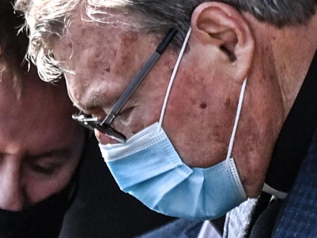 Australian Cardinal George Pell (R) gets into a car after landing at Rome's Fiumicino airport on September 30, 2020, returning for the first time since being acquitted of sexual abuse charges. - Pell arrived from Sydney to Rome on September 30, 2020 on a "private visit", just six months after Australia's High Court quashed his conviction on charges of molesting two choirboys in the 1990s. (Photo by Alberto PIZZOLI / AFP)