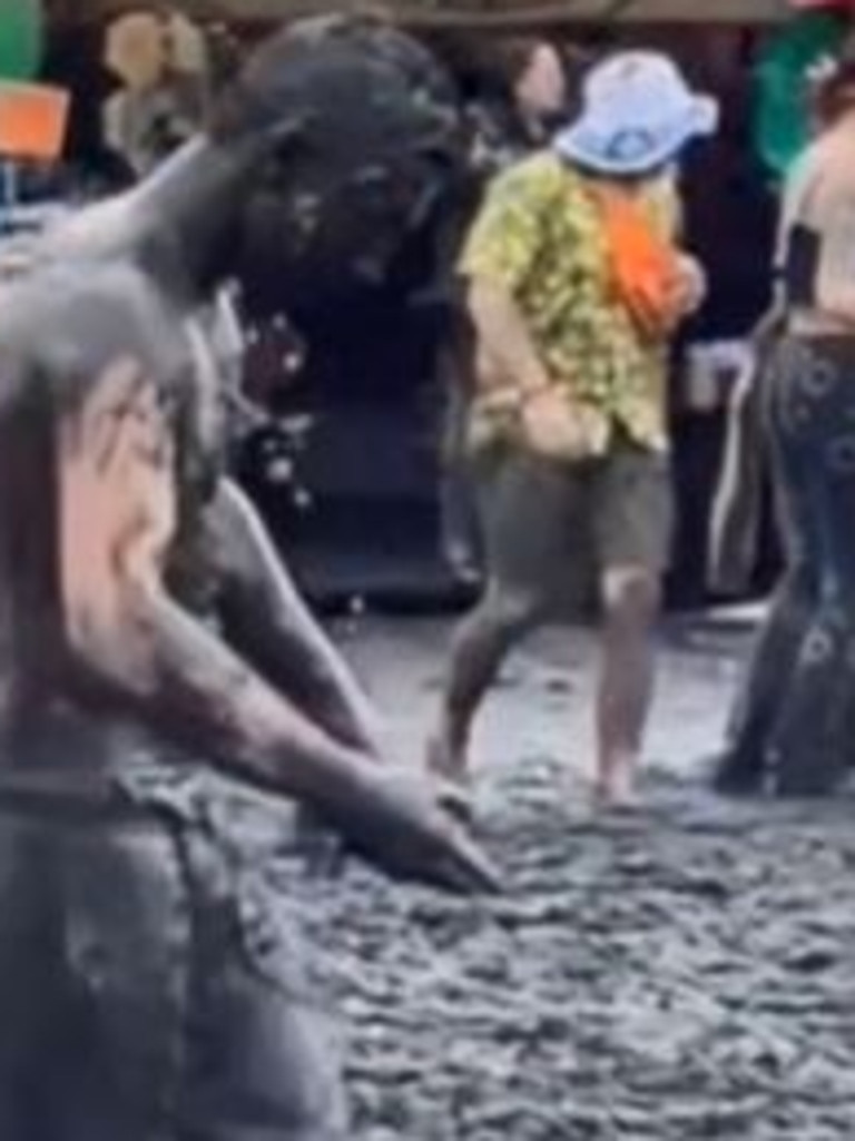 One man walked through the festival covered in mud. Picture: