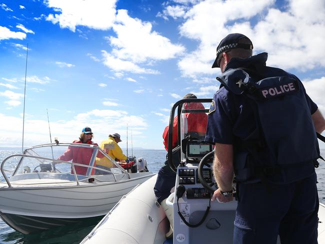 Marine police checking the safety equipment of boats during spot checks last weekend.