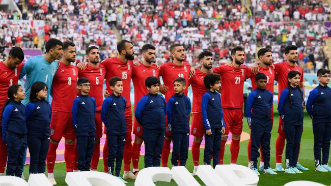 Iranian players line up for the national anthem