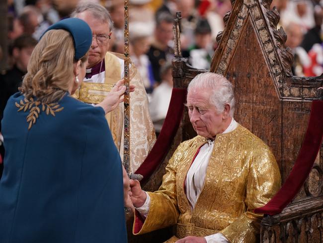 Ms Mordaunt hands King Charles the Jewelled Sword of Offering. Picture: Victoria Jones/Getty Images