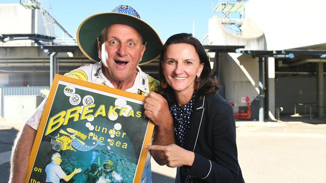 Steve Price and Claudia Brumme-Smith, CEO of Townsville Enterprise, outside Reef HQ which remains closed. Price shows an advertisement where he held a radio show at the aquarium in 1994. Picture: Shae Beplate.