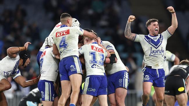 SYDNEY, AUSTRALIA - JUNE 28:  Matt Burton of the Bulldogs celebrates with team mates after kicking a golden point field goal in extra time to win the round 17 NRL match between Canterbury Bulldogs and Cronulla Sharks at Accor Stadium on June 28, 2024, in Sydney, Australia. (Photo by Cameron Spencer/Getty Images)