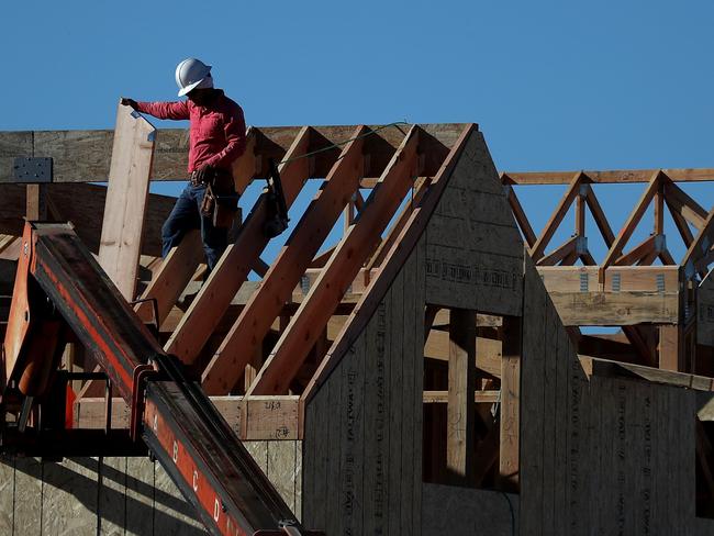 (FILES) This file photo taken on November 16, 2016 shows a worker on the roof of a home under construction at a new housing development in San Rafael, California.  Construction of new US homes slowed in March to its slowest pace in four months, with the pace of building falling sharply in the Mid-West, the Commerce Department reported on April 18, 2017. Analysts had been expecting a slowdown following a surge in construction during the unseasonably warm winter months of January and February.  / AFP PHOTO / GETTY IMAGES NORTH AMERICA / JUSTIN SULLIVAN