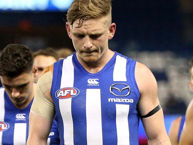 Jack Ziebell of the Kangaroos (centre) leads his team from the field following the Round 21 AFL match between the North Melbourne Kangaroos and the Western Bulldogs at Etihad Stadium in Melbourne, Sunday, August 12, 2018. (AAP Image/Hamish Blair) NO ARCHIVING, EDITORIAL USE ONLY