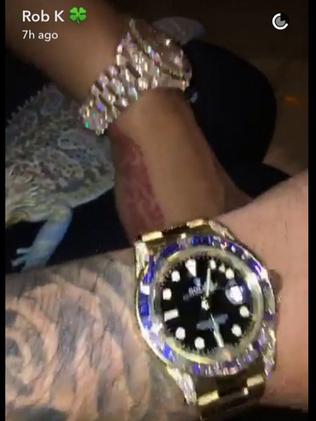 Rob shows off his Rolex with girlfriend Blac Chyna.