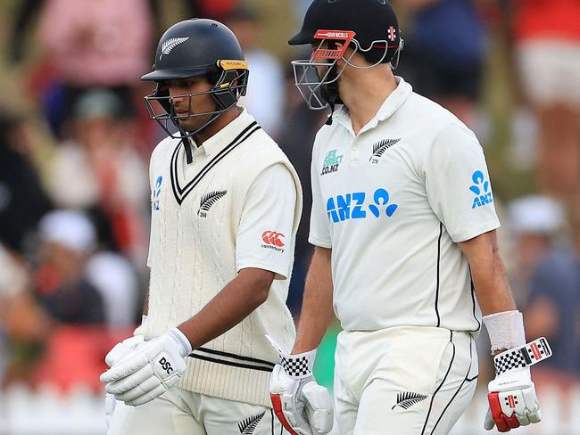 New Zealand's Rachin Ravindra (L) and teammate Daryl Mitchell walk off.