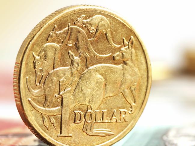 Generic photo of an Australian dollar coin .. Aussie one dollar coins, on a twenty dollar note.