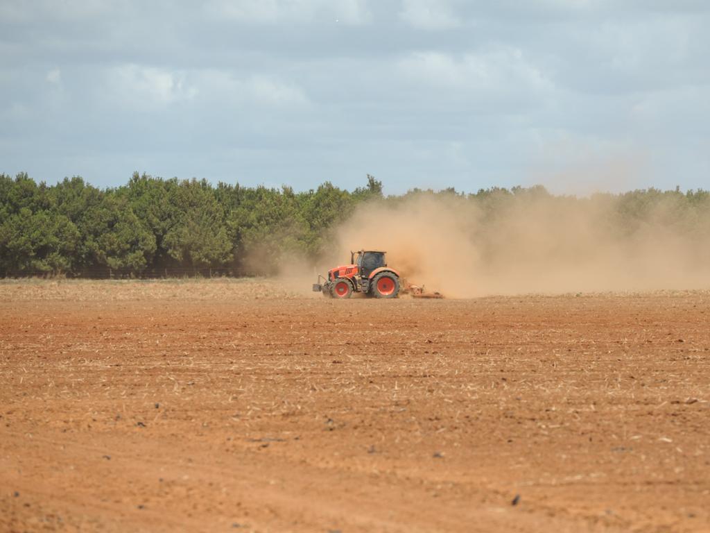 Farming dust. A tractor leaves a trail of dust on a Bundaberg farm.