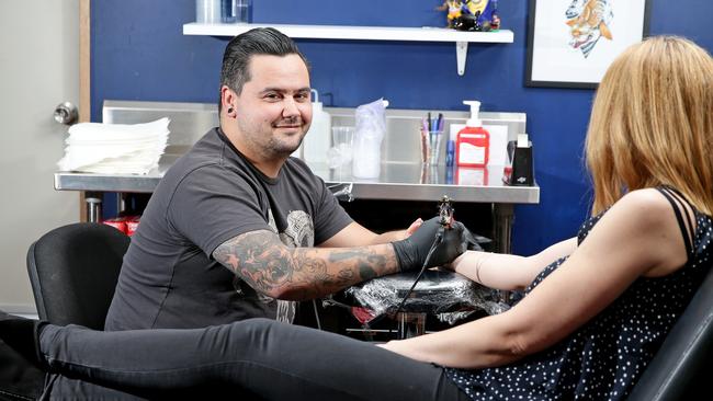 McMiles at work at Manly Tattoo. Picture: Troy Snook