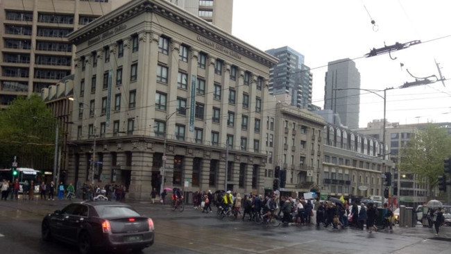 Protesters block the road in Collins St, Melbourne. Picture Twitter.