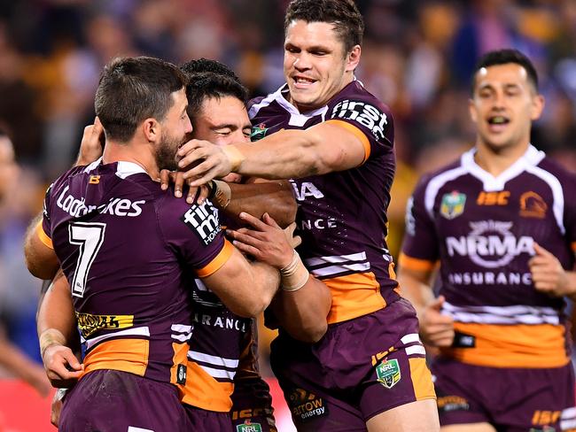 Teammates swarm over Kodi Nikorima oafter his try.