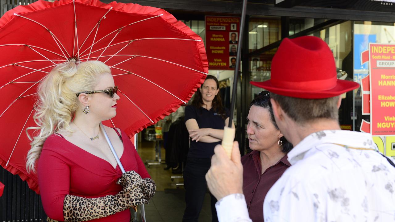 Sex workers sporting red umbrellas, a common symbol of sex worker rights.