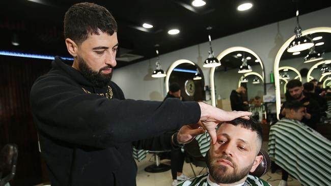 Anmol Nabil Jameel is a refugee who escaped persecution in Iraq. He now owns a successful barber shop in Corio Village. Picture: Alan Barber