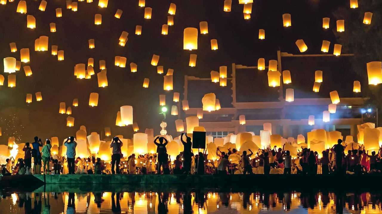 People release sky lanterns to pay homage to the triple gem: Budhha, Dharma and Sangha during Yi Peng festival. Picture: gagarych