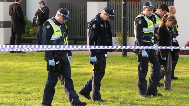 Police search the crime scene for evidence. Picture: David Crosling