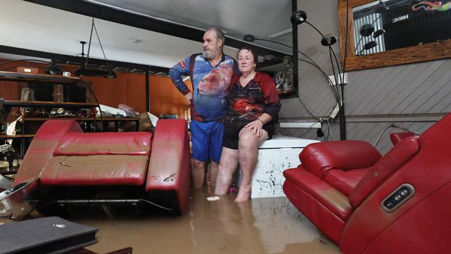 Clitheroe Street residents David and Tracy Ebert look for items to salvage from the lounge room, after flood water inundated their Cardwell home. Picture: Brendan Radke