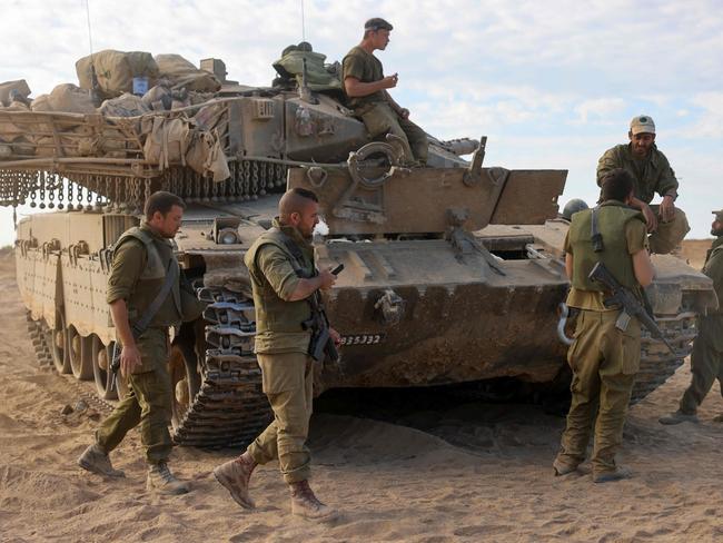 Israeli soldiers deploy near the border with Gaza on October 17, 2023. US President Joe Biden will visit Israel on October 18 in a show of "ironclad" support as Washington tries to prevent the escalating war against Hamas in Gaza from spilling into a wider Middle East conflict. (Photo by Menahem KAHANA / AFP)