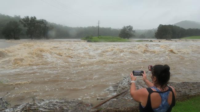 Wet weather continues to impact the Gold Coast. Oxenford local Cheryl Glanz records the floodwater pouring over the Oxenford Weir. Picture: Glenn Hampson.