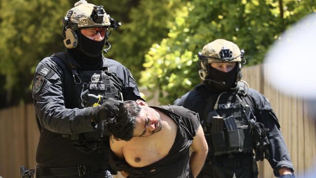 Tactical officers arrest a man after a police operation in Gladesville, where an officer was allegedly stabbed in the head. Picture: Toby Zerna