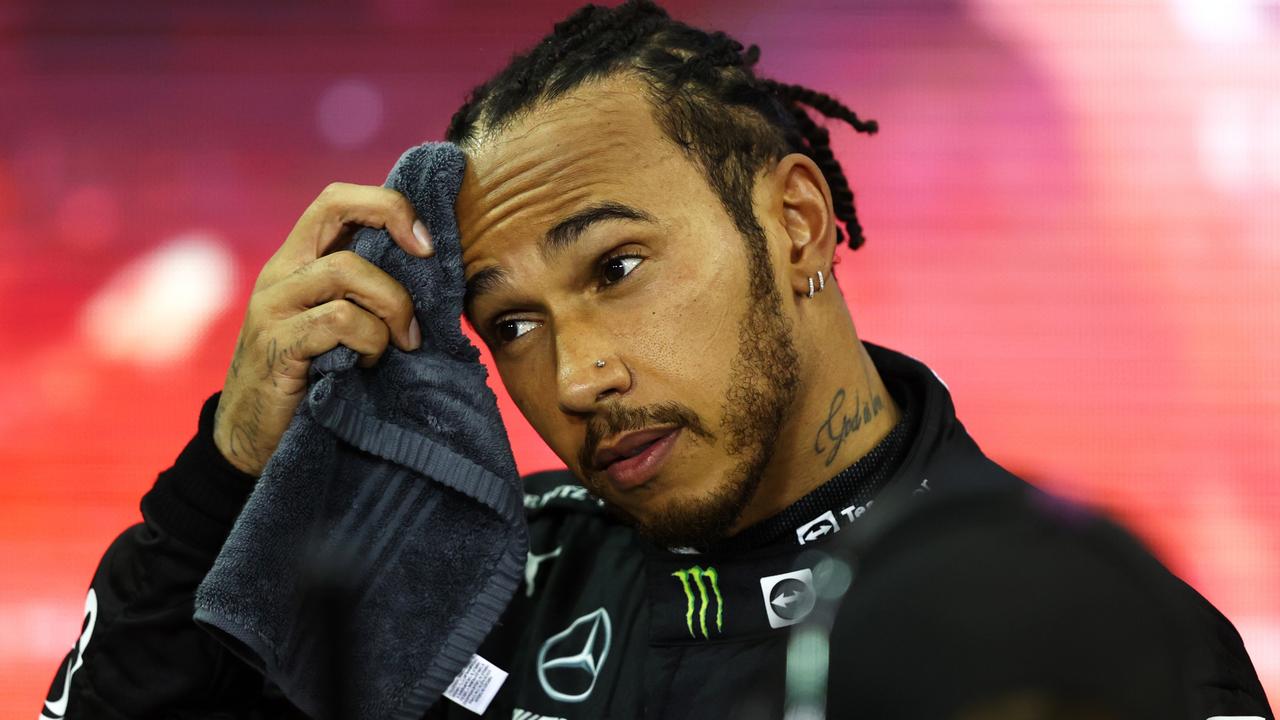 ABU DHABI, UNITED ARAB EMIRATES - DECEMBER 12: Second placed and championship runner up Lewis Hamilton of Great Britain and Mercedes GP looks dejected in parc ferme during the F1 Grand Prix of Abu Dhabi at Yas Marina Circuit on December 12, 2021 in Abu Dhabi, United Arab Emirates. (Photo by Bryn Lennon/Getty Images) *** BESTPIX ***