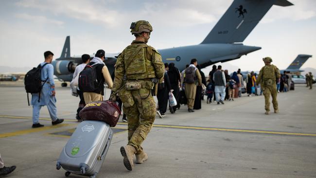 Australian citizens and visa holders prepare to board an RAAF C-17A Globemaster III at Hamid Karzai International Airport, Kabul. Picture: ADF/AFP