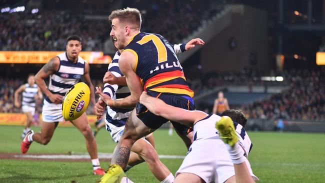 Jordan Gallucci of the Crows is tackled by Tim Kelly of the Cats on Thursday. Picture: AAP Image/David Mariuz