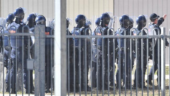 Riot police enter the youth justice centre. Picture: Jake Nowakowski