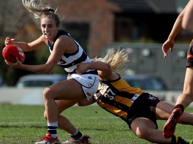 Amy McDonald of the Cats is tackled by Tayah Kelly of the Hawks during the VFLW match Hawthorn v Geelong played at Box Hill City Oval on Saturday 6th July, 2019.