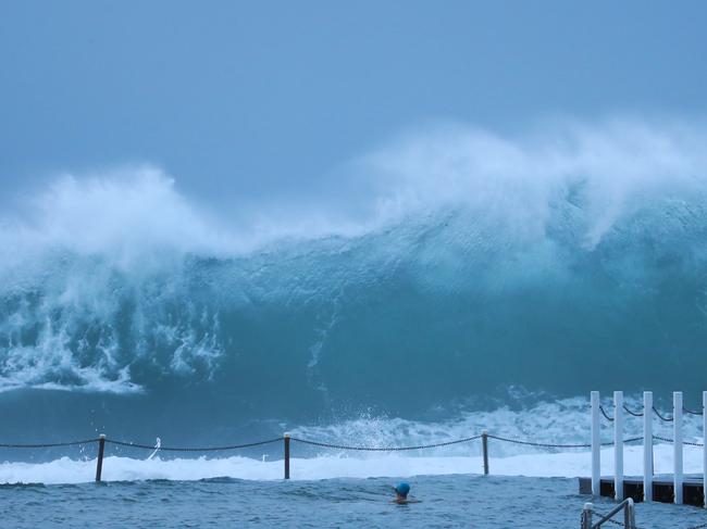 Spectators and surfers were having a swell time at North Narrabeen at low tide. Picture: John Grainger