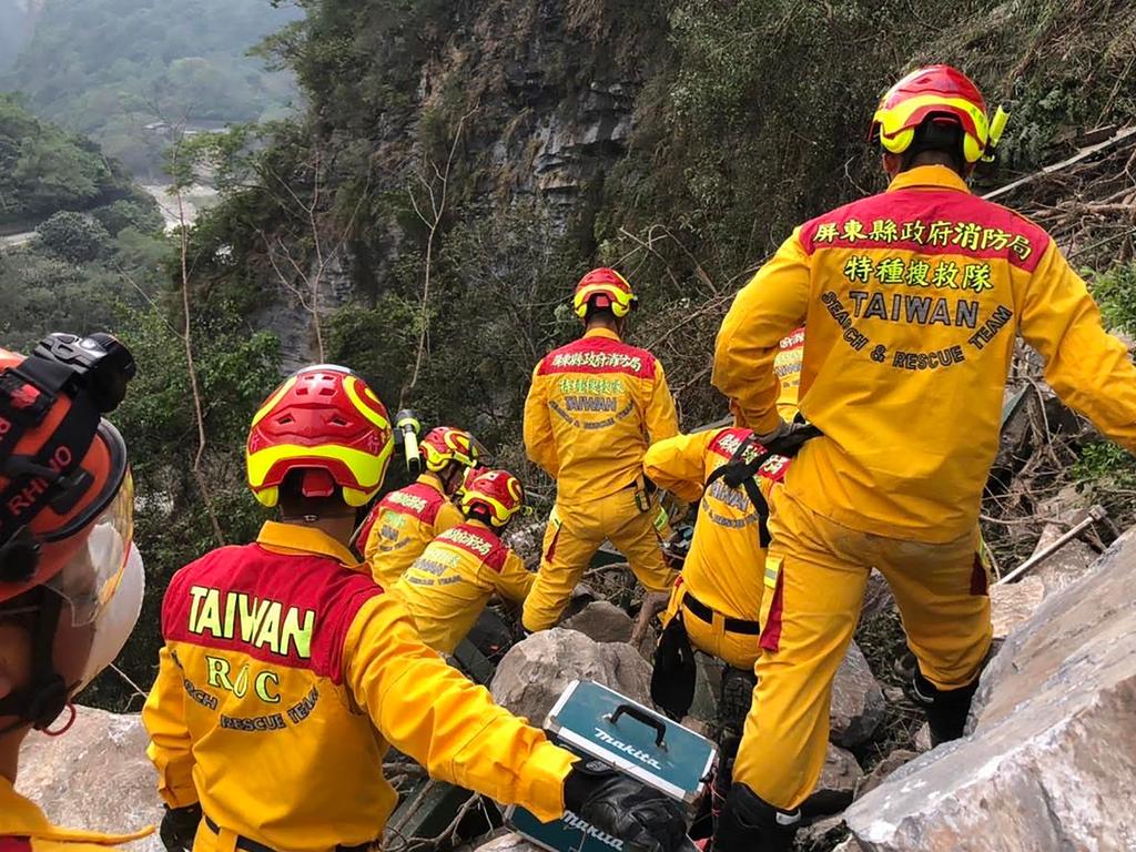 Search and rescue personnel working on a mountainside during the search for the body of a hiker in Hualien, which was later recovered. Picture: AFP