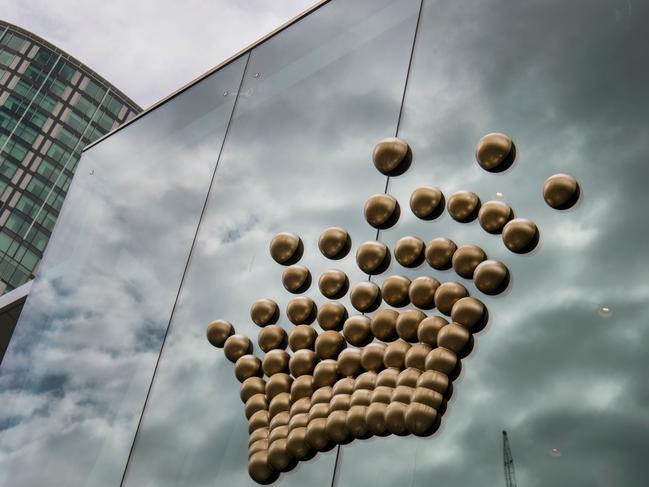 The Crown Casino logo adorns the side of their casino in Melbourne on April 9, 2019. - Australian gambling giant Crown Resorts on April 9 confirmed a takeover offer from US gaming group Wynn Resorts, estimated to be worth more than USD 7 billion, sending the firm's shares surging by a quarter. (Photo by William WEST / AFP)