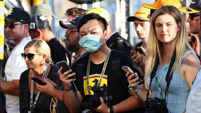 A masked fan in the pitlane at Albert Park this week. Picture: Robert Cianflone/Getty Images