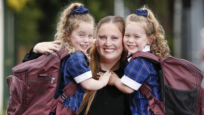 Simone Lichtenstein with her twin daughters Mila and Mika, who are very excited for their first day of school. Picture: David Caird