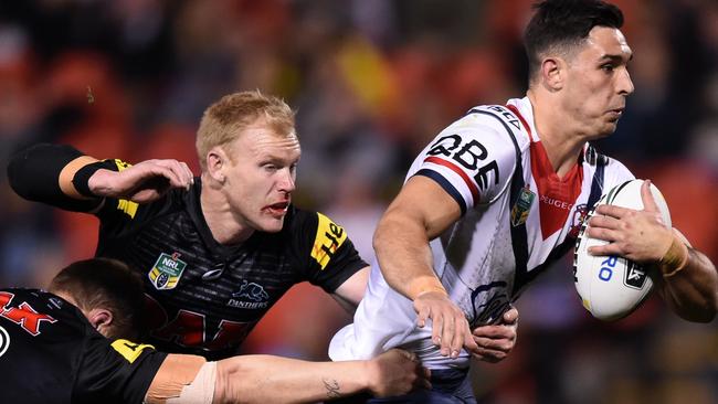 Rooster Ryan Matterson s is tackled by Panthers Peter Wallace (centre) and Trent Merrin during the round 22 NRL match at Pepper Stadium. Picture: Paul Miller AAP.