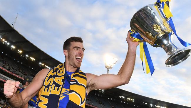 Scott Lycett holds the premiership trophy after winning the 2018 AFL Grand Final.