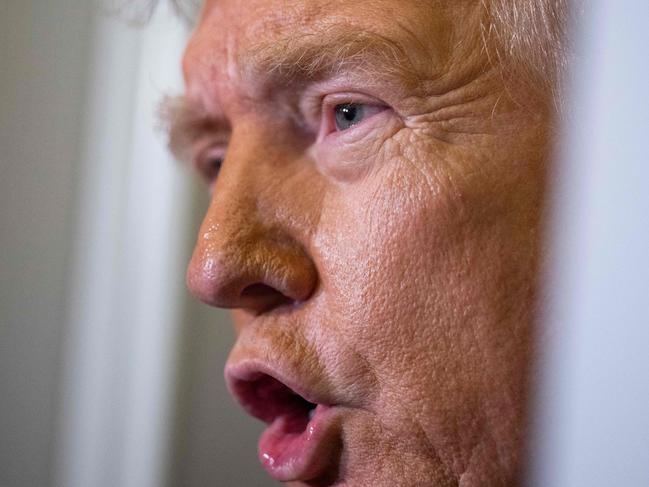 US President Donald Trump speaks to journalists aboard Aire Force One as he travels from West Palm Beach back to Washington on March 9, 2025. (Photo by ROBERTO SCHMIDT / AFP)