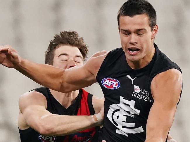 Zach Merrett of the Bombers strikes Jack Silvagni of the Blues to the ribs and gets suspended for a week during the Round 4 AFL match between the Essendon Bombers and the Carlton Blues at the MCG in Melbourne, Saturday, June 27, 2020. (AAP Image/Michael Dodge) NO ARCHIVING, EDITORIAL USE ONLY