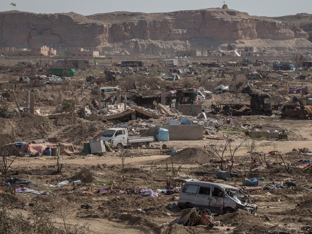 Syrian Defence Force flags are seen flying over the destroyed ISIS encampment on March 23, 2019 in Baghouz, Syria. Picture: Chris McGrath/Getty Images