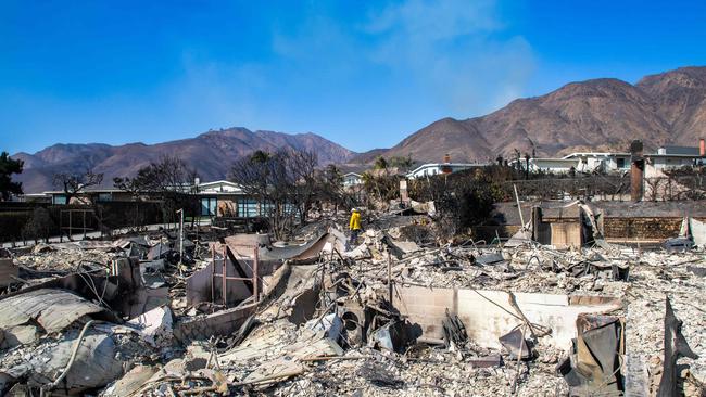 A firefighter inspects a burned house from the Palisades Fire. Picture: Getty