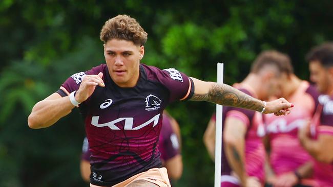 Reece Walsh in flight at Broncos training at Red Hill ahead of his trial comeback.