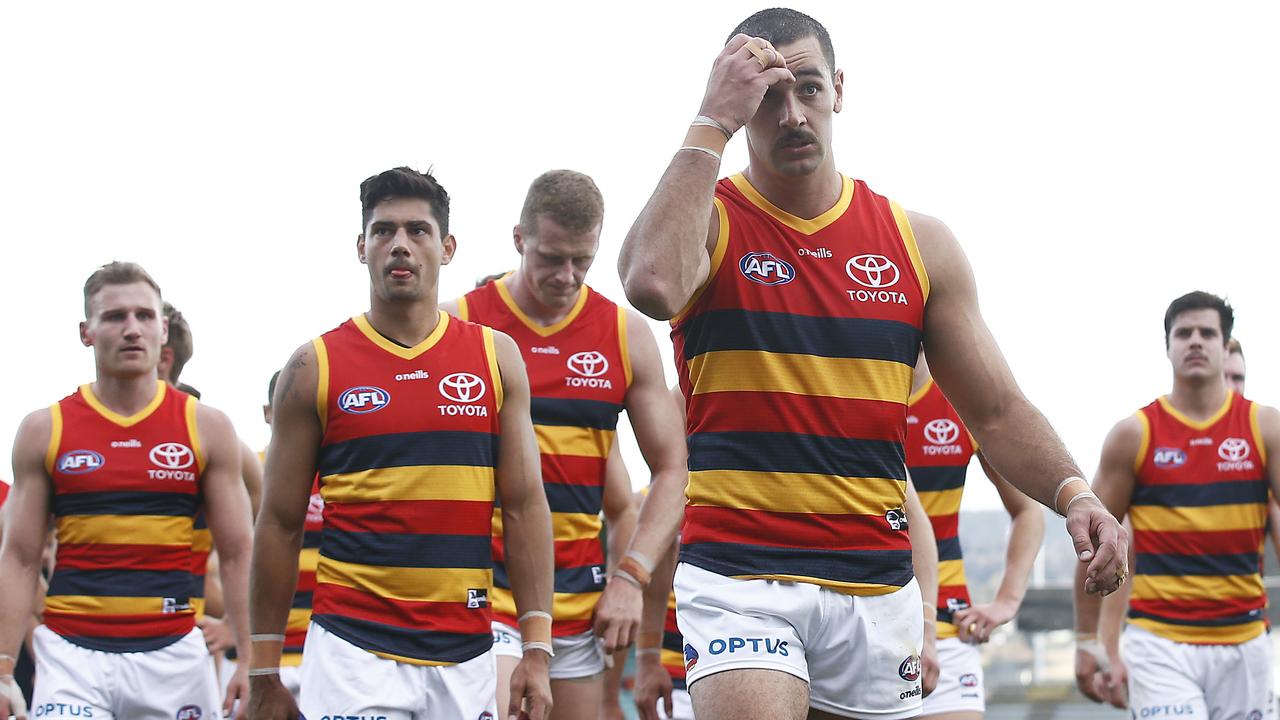 Crows players leave the field looking dejected after their loss. Picture: Getty Images